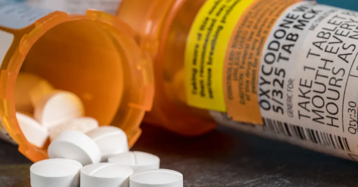 a tipped over bottle of oxycodone, illustrating opioid overdose