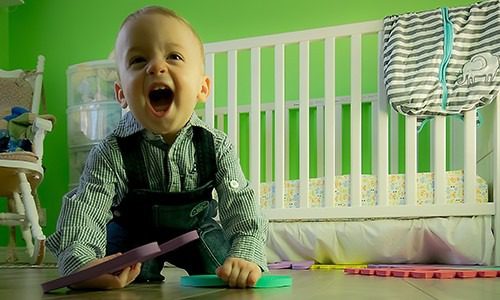 photo of an infant on the floor, illustrating home safety tips