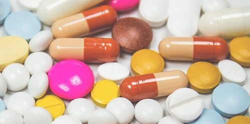 photo of many colorful pills and tablets, illustrating How to Dispose of Old Medicines