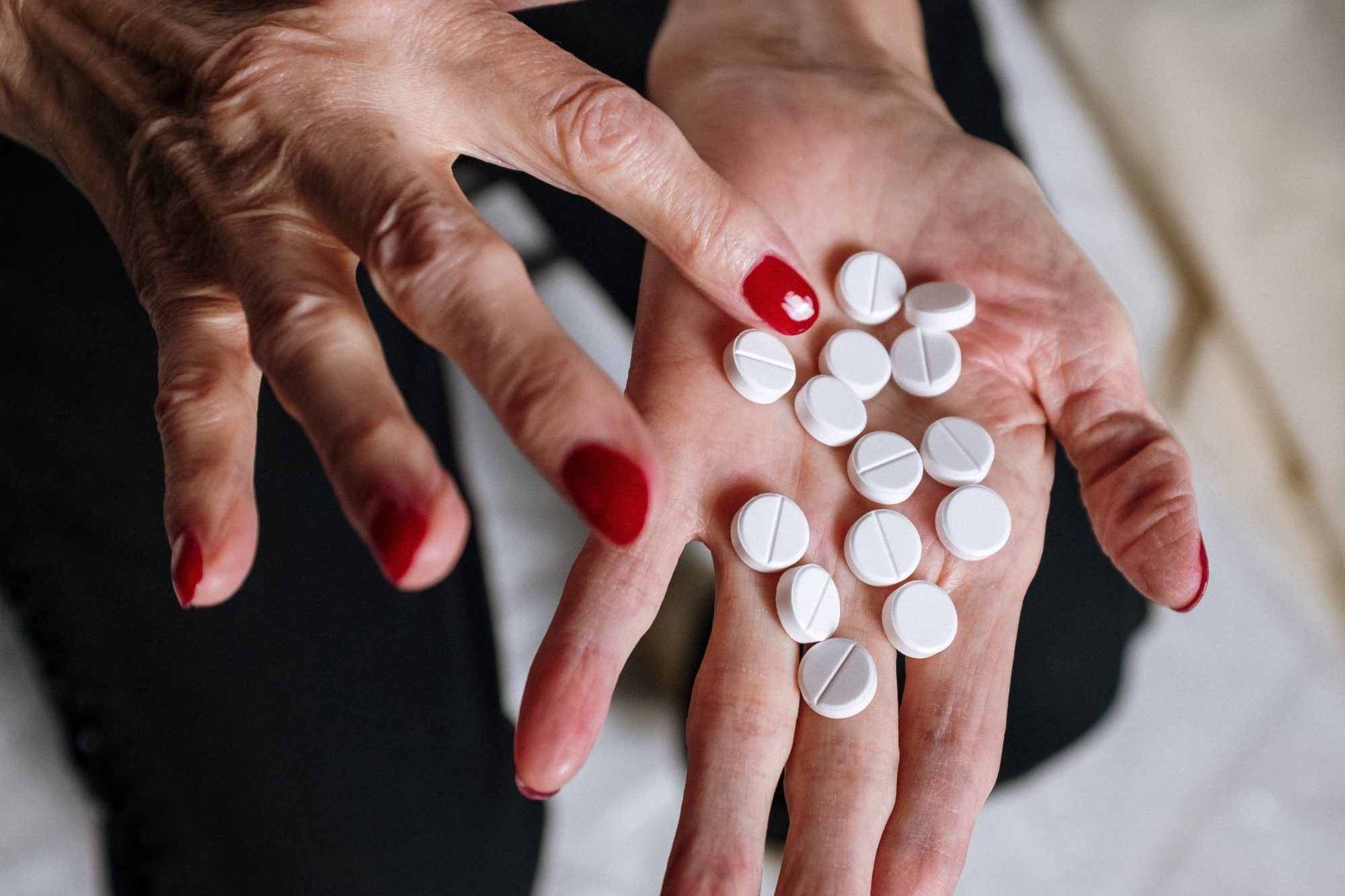 photo of a woman's hand holding many pills, illustrating the importance of medication safety